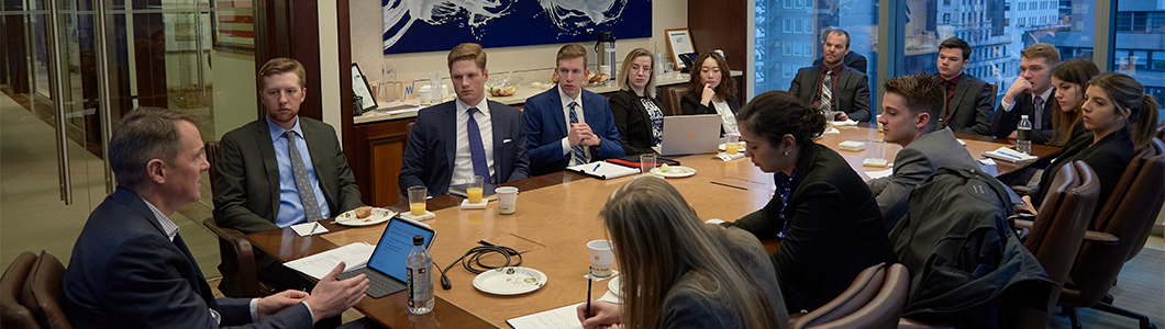 A group of students gathering in a meeting room.