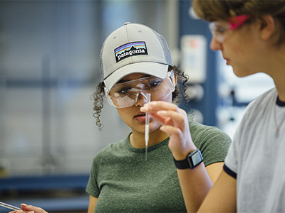 Student examining a pipette