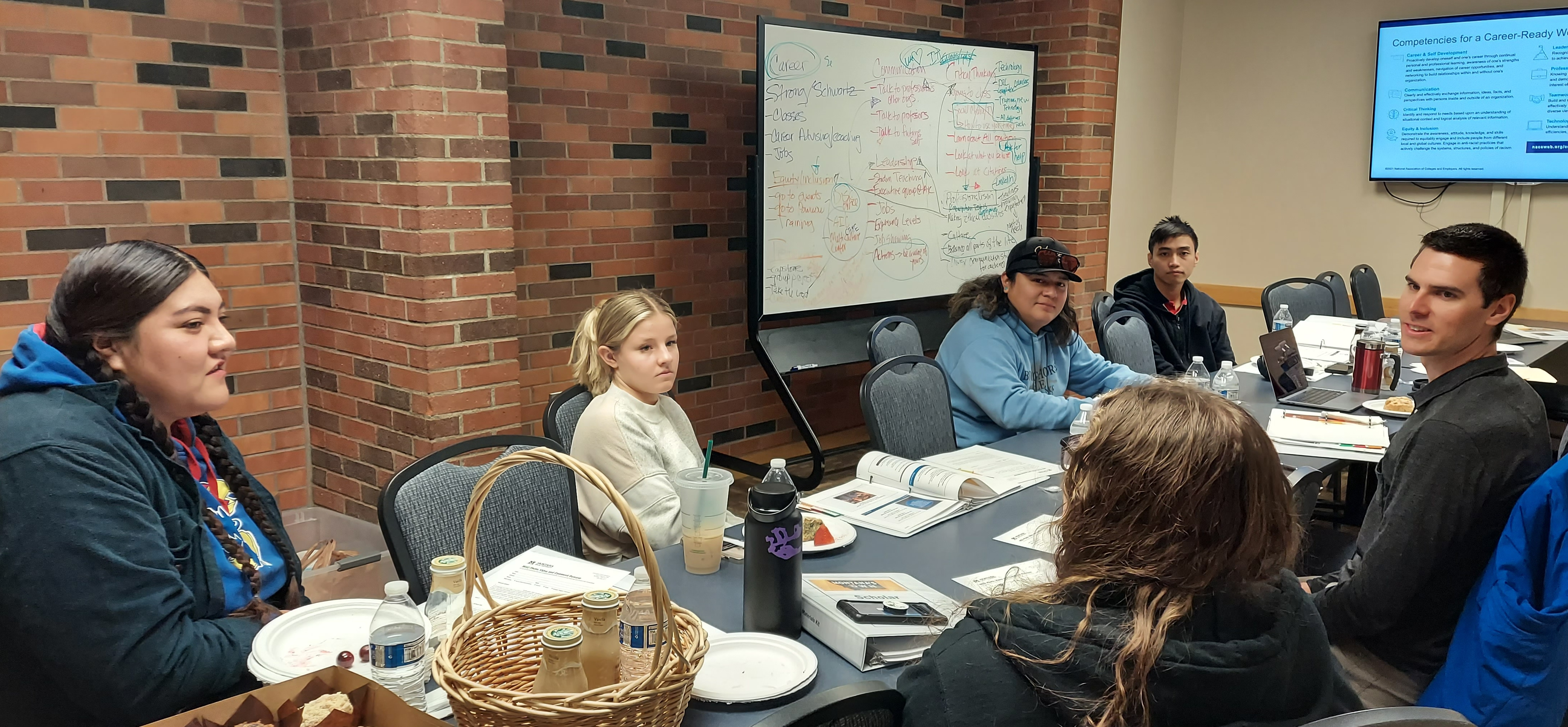 Montana's Own Scholars sitting around a table.