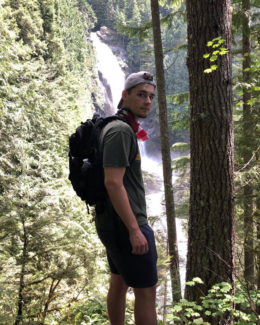 Logan with a waterfall in the background