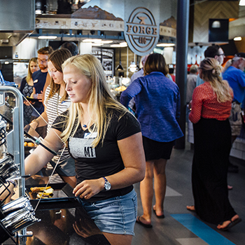 students in Rendezvous Dining Pavilion plating food