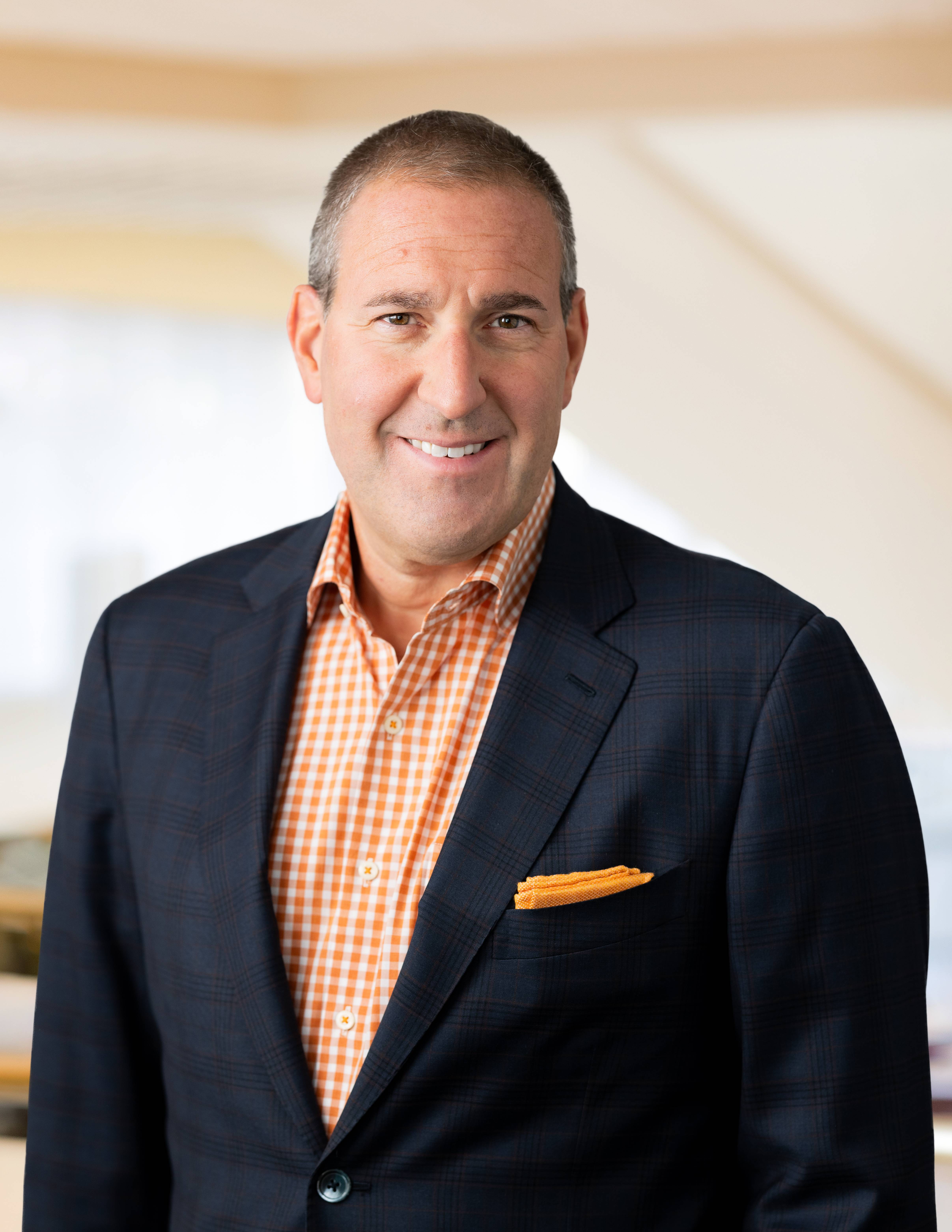 Image of man waring suit and gingham button down