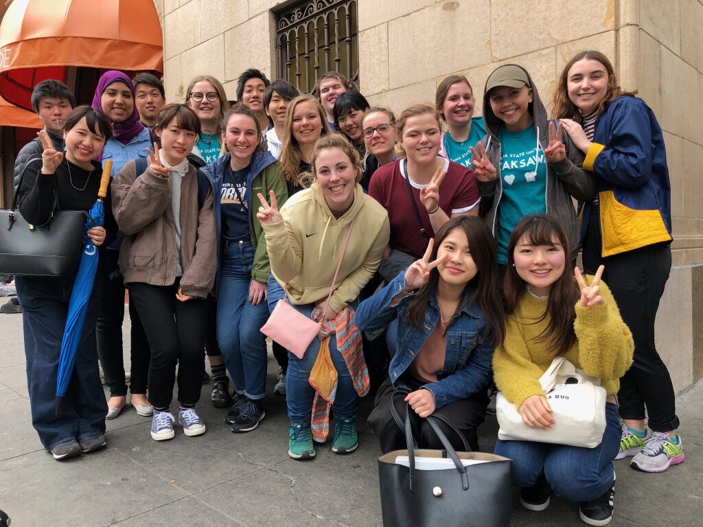 Group of studnets posing on a city street