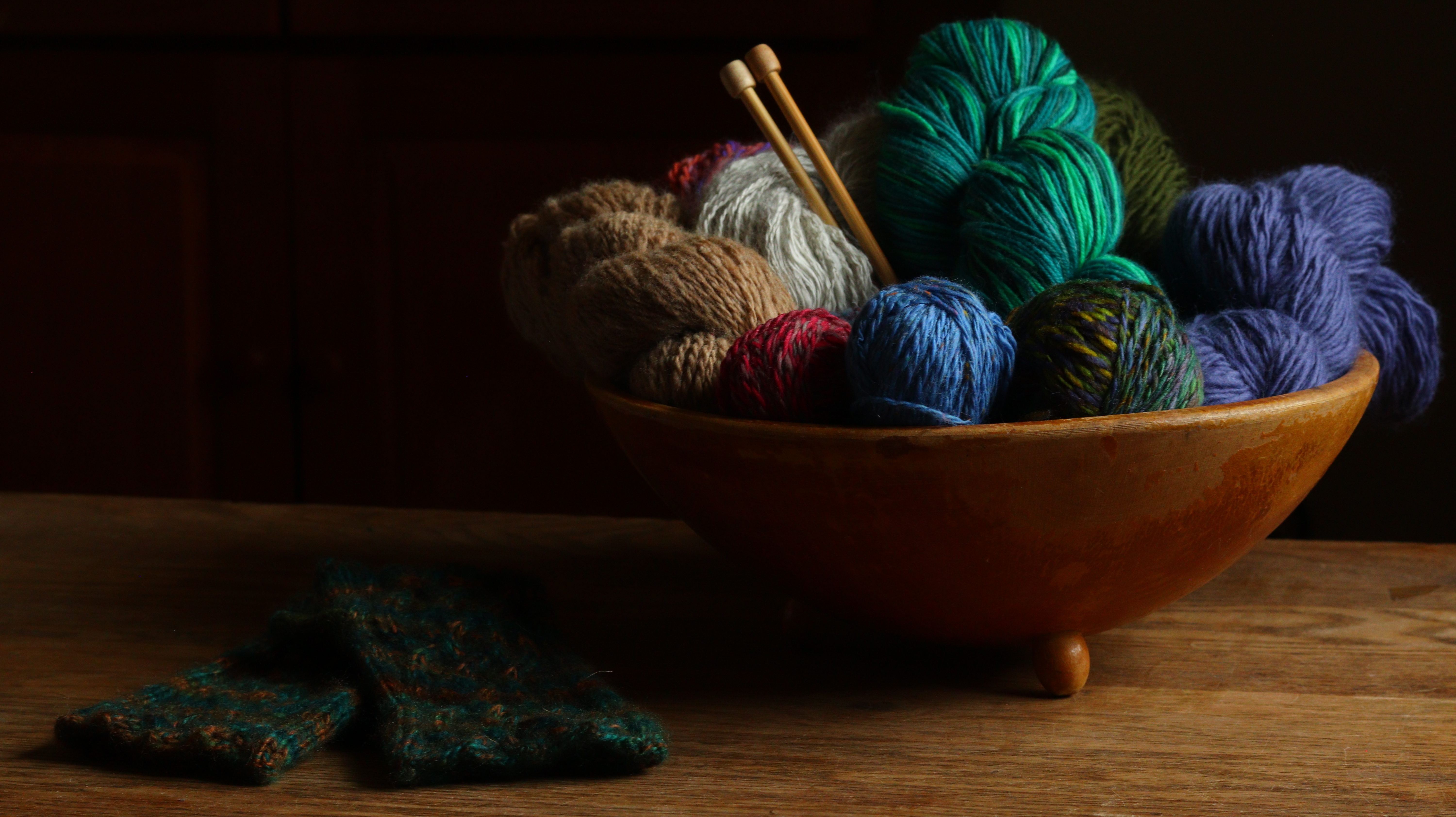 Bowl of yarn with knitting needles