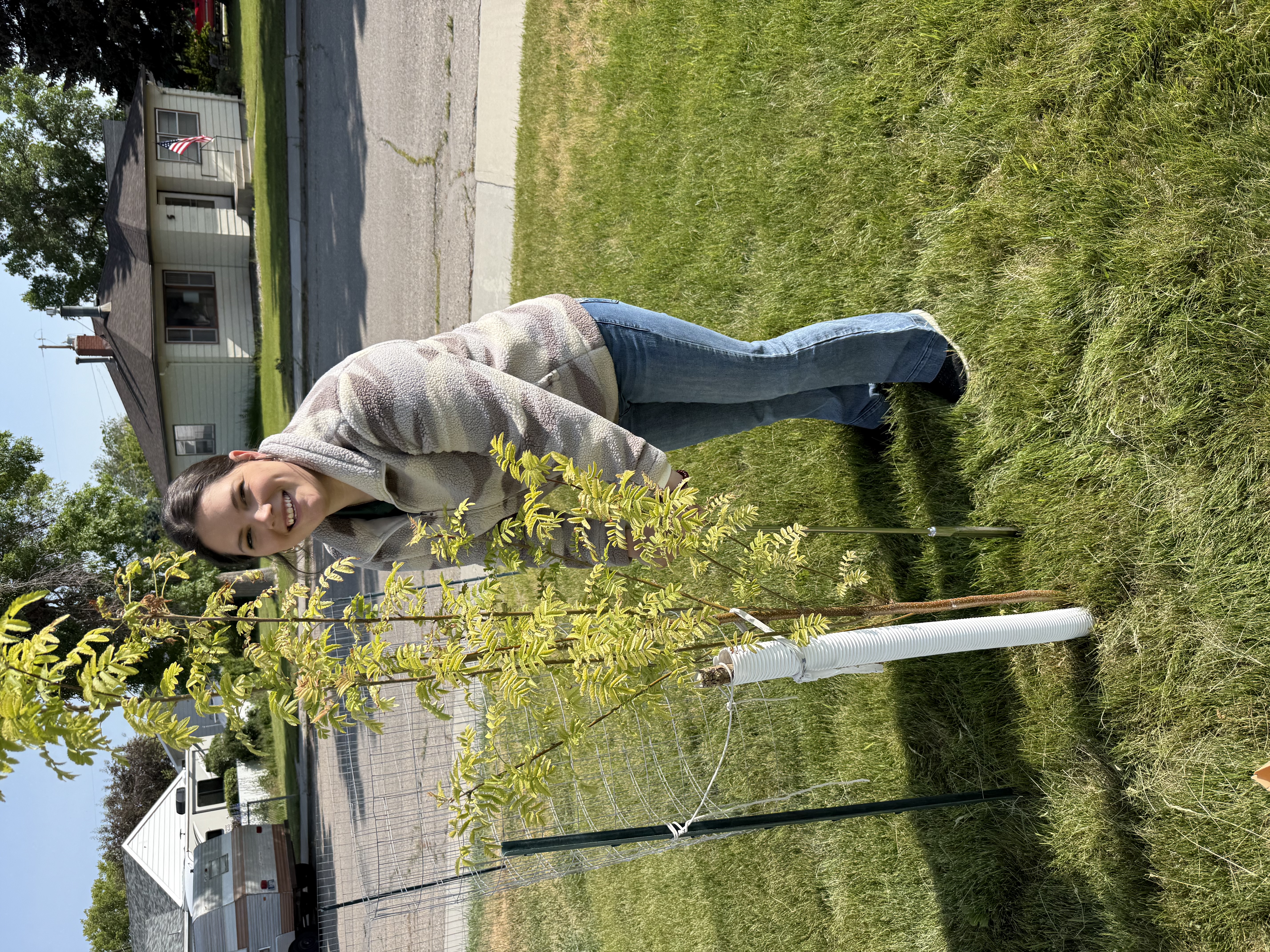 Intern Janna Groover takes soil samples around a tree on horticultural site visit
