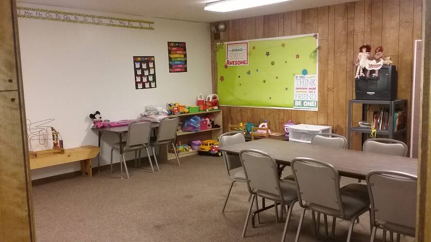 room with table, chairs, and toys