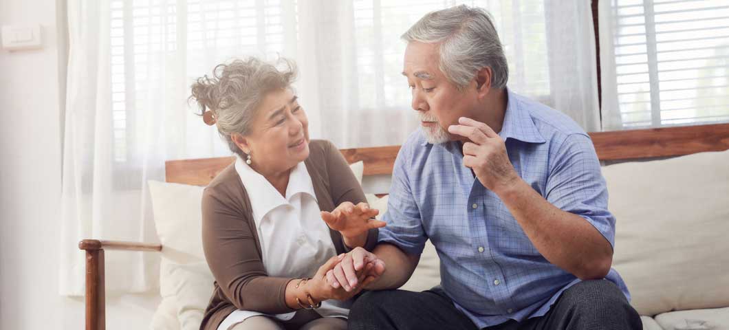 Wife helping husband with Alzheimers Disease