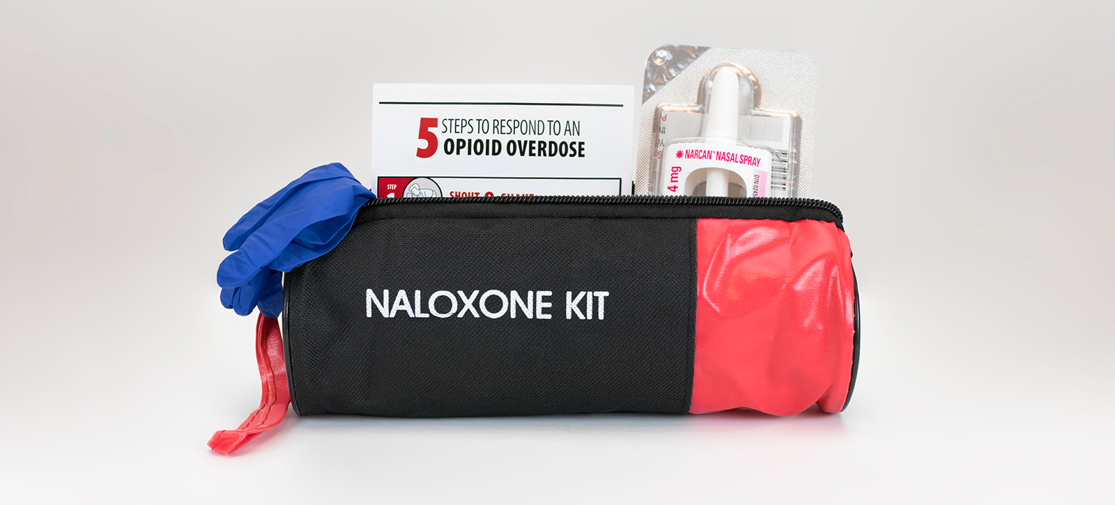 A bag with text that says "Naloxene Kit", filled with opioid overdose resources