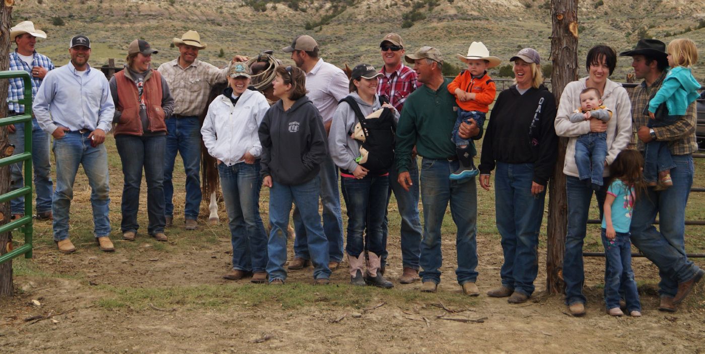 a large group of men, women and children of all ages gather together for a group photo