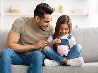 girl saving money in her piggy bank