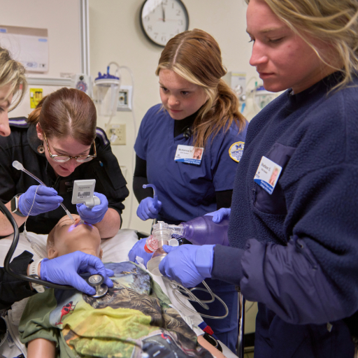 students working in simulations with flight nurses