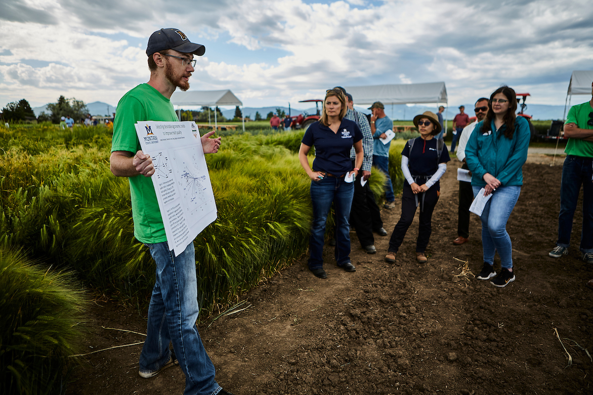 man with placard and group at Post Farm