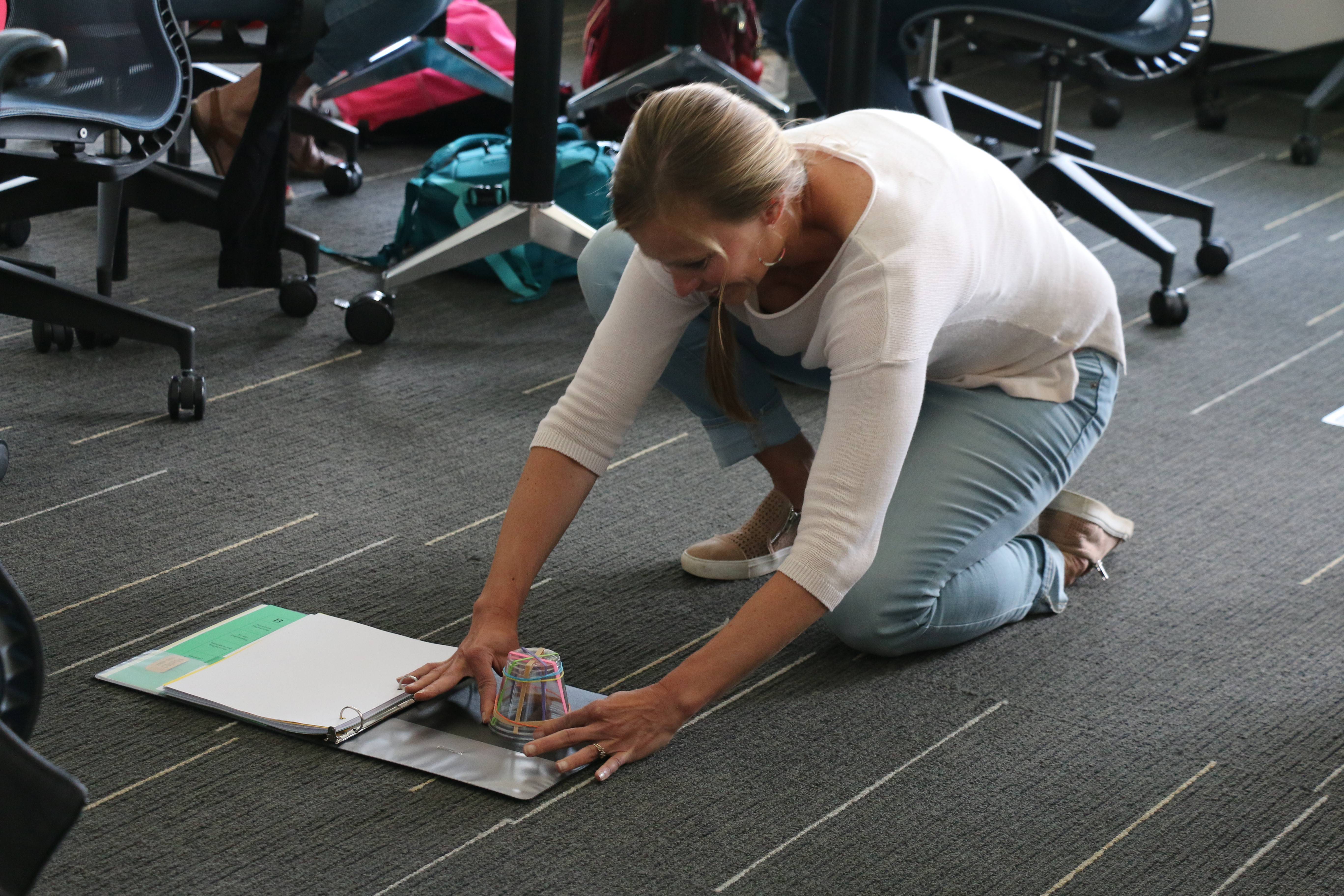 Woman participates in activity on floor