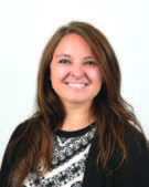 Headshot of a young woman, Chelsea Koessel, smiling and looking straight ahead.