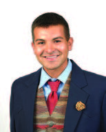 Headshot of a young man, Ty Running Fisher, smiling and looking straight ahead.